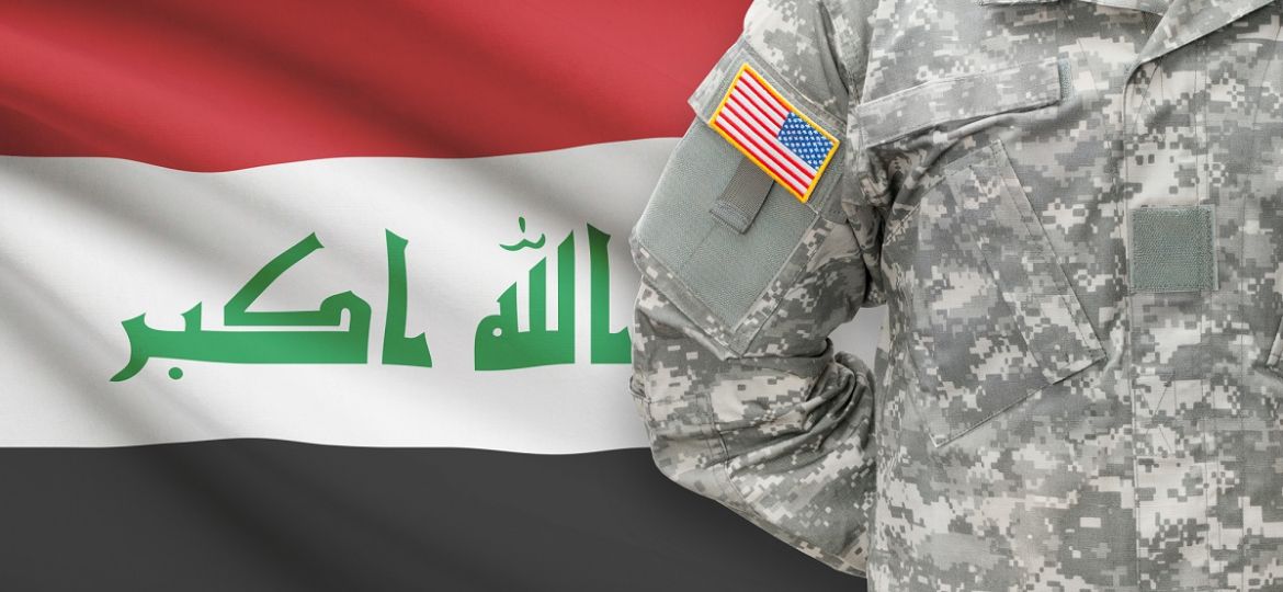American soldier in front of Iraq flag