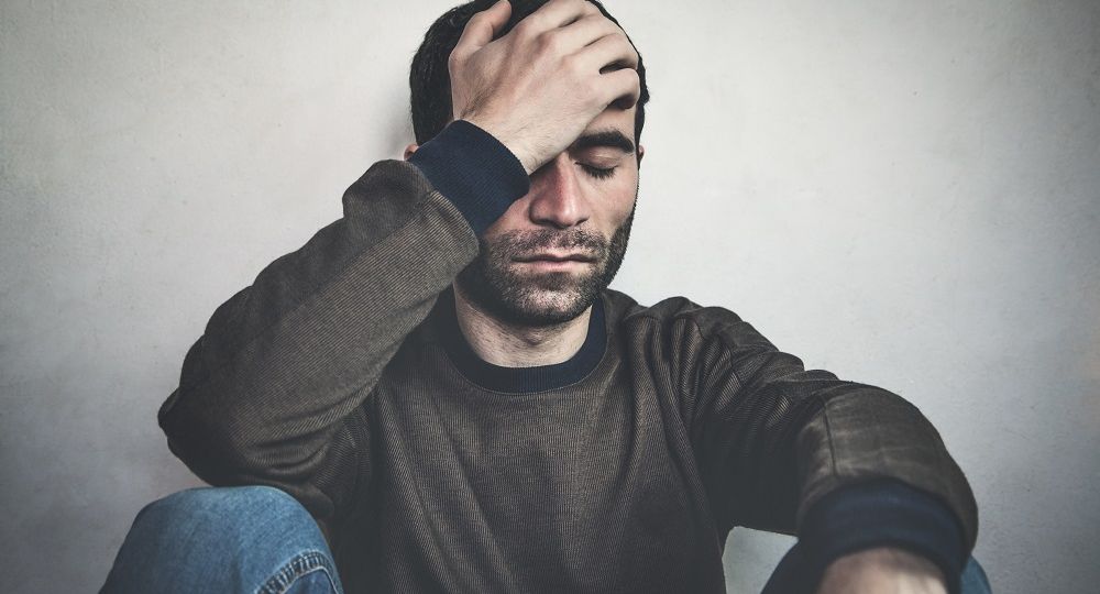 Man Holding Head in Distress